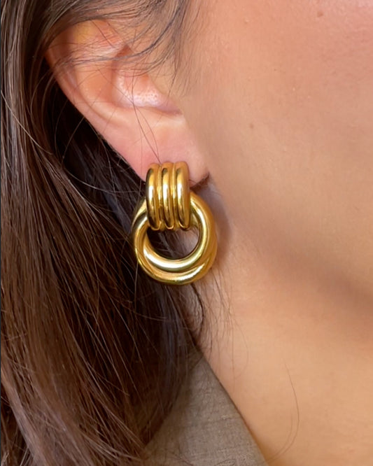 Woman wearing gold Amara Knot Earring close-up, large statement earrings for women, vintage-inspired hypoallergenic jewelry