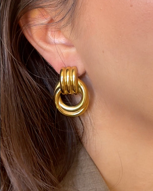 Woman wearing gold Amara Knot Earring close-up, large statement earrings for women, vintage-inspired hypoallergenic jewelry